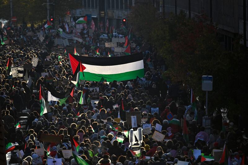 Protesters hold Palestinian flags during a demonstration in Brussels on Saturday to demand an immediate ceasefire in Gaza. AFP