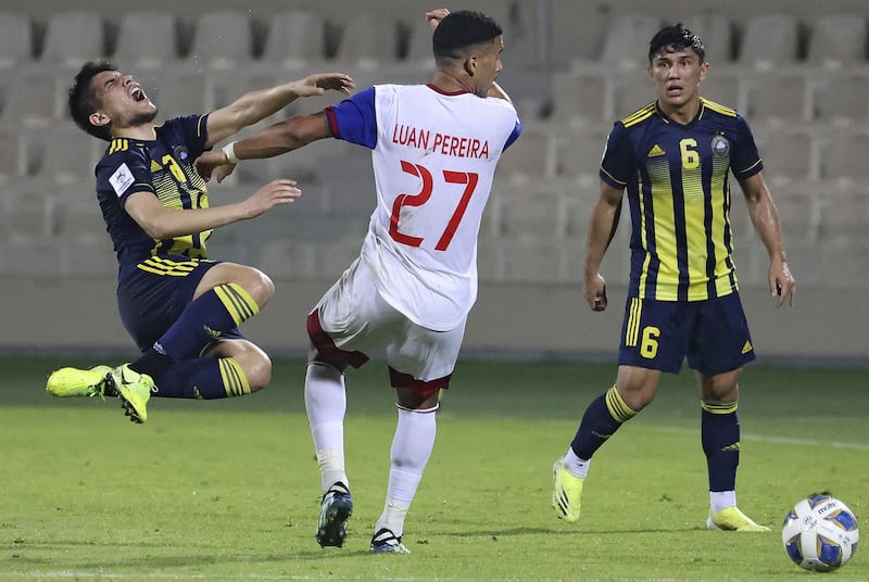 Sharjah's midfielder Luanzinho vies for the ball with Pakhtakor's midfielder Abror Ismoilov, left. AFP