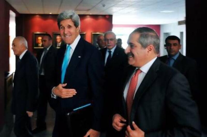 US secretary of State John Kerry, centre, Jordan's foreign minister Nasser Judeh, right, and Egypt's foreign minister Mohammed Kamel Amr, left, arrive for a meeting with the Arab League Peace Initiative in Amman.