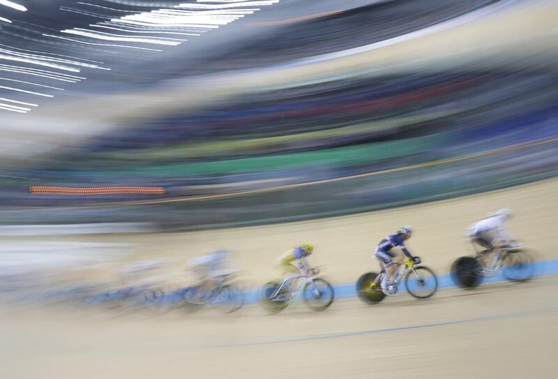 In this image made with a slow camera shutter speed, competitors race in the Women’s Omnium Tempo Race 24 at the World Track Cycling championships in Hong Kong. Kin Cheung / AP