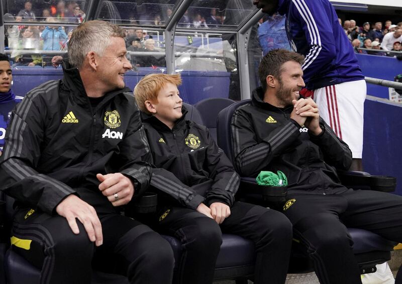 Manchester United manager Ole Gunnar Solskjaer, left, and his son Elijah Solskjaer watch the game. Reuters