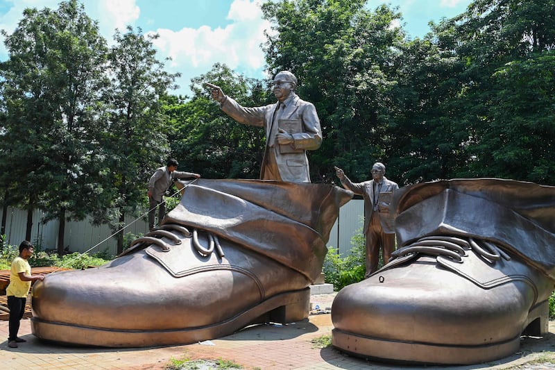 Labourers work on the shoes of a 125-feet tall statue of social reformer Dr Ambedkar in Hyderabad. AFP