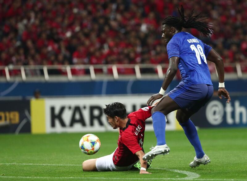 Bafetimbi Gomis (R) fights for the ball with Urawa's Daisuke Suzuki during the second leg of the AFC Champions League final at Saitama Stadium in Saitama. AFP