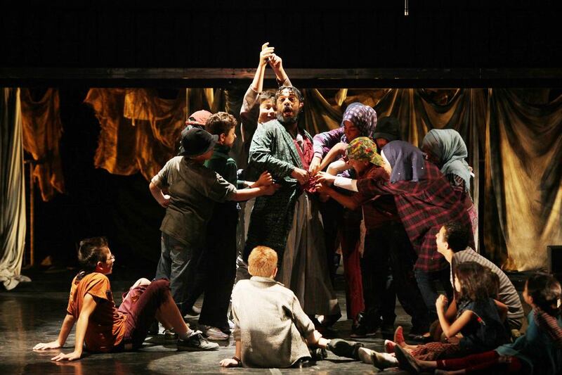 The amateur cast comprised of Jordanian and Syrian refugees act in a scene of an Arabic adaptation of 'Oliver'. Salah Malkawi for The National
