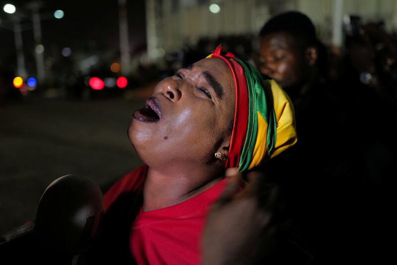 A mourner reacts as the body of late Ghanaian footballer, Christian Atsu, who died in the earthquake in Turkey, arrives at the Kotoka International Airport in Accra, Ghana. Reuters