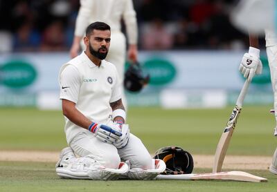 Cricket - England v India - Second Test - Lord’s, London, Britain - August 12, 2018   India's Virat Kohli reacts before receiving treatment from medical staff for a back injury   Action Images via Reuters/Paul Childs