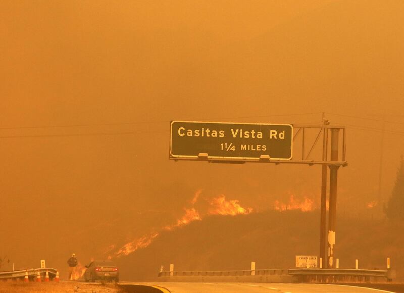 Flames and smoke shroud State Route 33 as a wildfire burns in Ventura, California. Daniel Dreifuss via AP