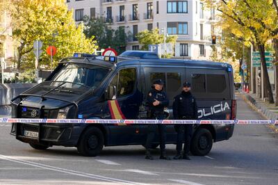 Police officers stand guard as they cordon off the area next to the US embassy in Madrid after a suspicious envelope was found. AP