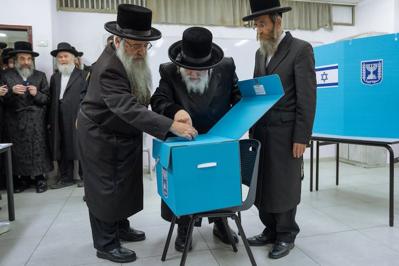 Ultra-Orthodox Jews watch their Rabbi Israel Hager vote during Israeli elections in Bnei Brak. AP 