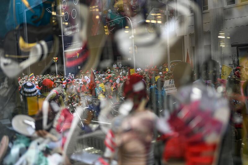 Government supporters, reflected in a storefront window, protest against US sanctions as they celebrate May Day in Caracas, Venezuela, amid the coronavirus pandemic. AP Photo