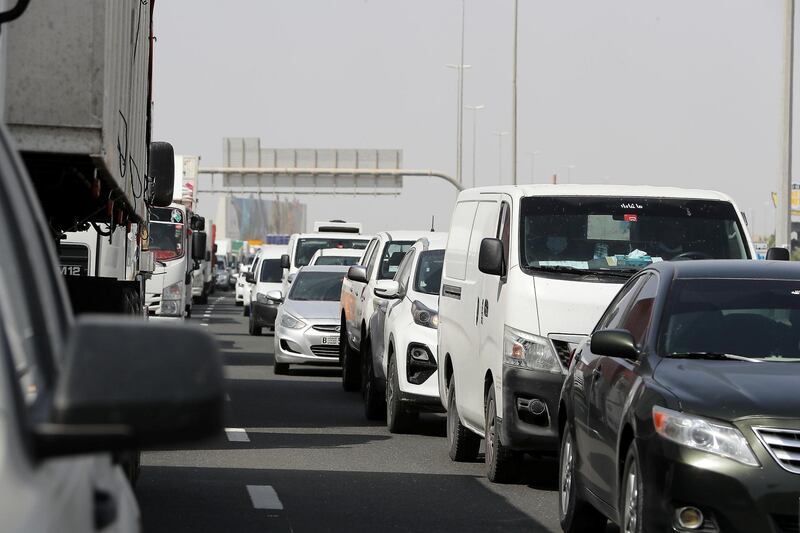 DUBAI, UNITED ARAB EMIRATES , June 2 – 2020 :- Traffic jam at the Dubai border going towards Abu Dhabi on Sheikh Zayed road in Dubai. Abu Dhabi Police checking the movement permits at the police checkpoint on the Dubai – Abu Dhabi border on Sheikh Zayed road in Dubai. Abu Dhabi impose one week ban starting from Tuesday on travel on entering and leaving the emirate to reduce the spread of Covid-19  and ensure its huge testing drive works. (Pawan Singh / The National) For News/Online 