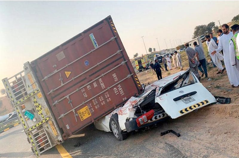 A minibus driver was killed and his passenger sustained serious injuries after a lorry fell on top of the vehicle in Umm Al Quwain on Sunday. Courtesy Umm Al Quwain Media Office