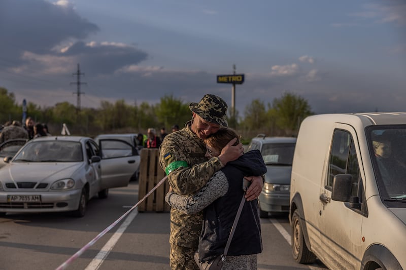 Hryhorii, a member of the Ukrainian military meets his wife Oksana, who fled from the Russian-occupied Novomykhailivka village, at the evacuation point in Zaporizhzhia. EPA