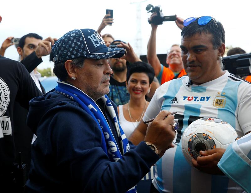 Diego Maradona signs an Argentina shirt for a Dynamo Brest fan. Reuters