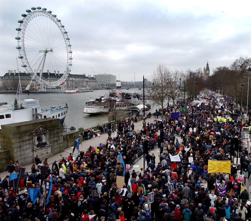 Protesters on the Embankment pass the London Eye on the way to Hyde Park during the anti-war protest