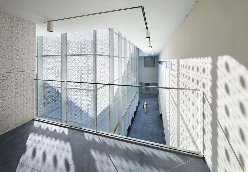 Hanging from the ceiling in the museum’s wide atrium, where light filtered through mashrabiya patterns on the glass walls, is a carpet decorated with 1.2 million gold and silver pins, all of which were placed by hand.