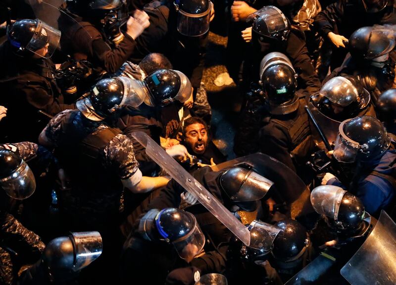 Riot police arrest an anti-government protester who was protesting outside a police headquarters in Beirut. AP Photo