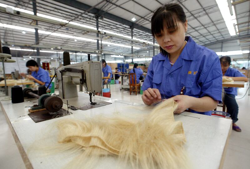 The Hong Kong-China joint-venture factory manufactures wigs and other hair products that are shipped to Africa, Europe and America. AFP