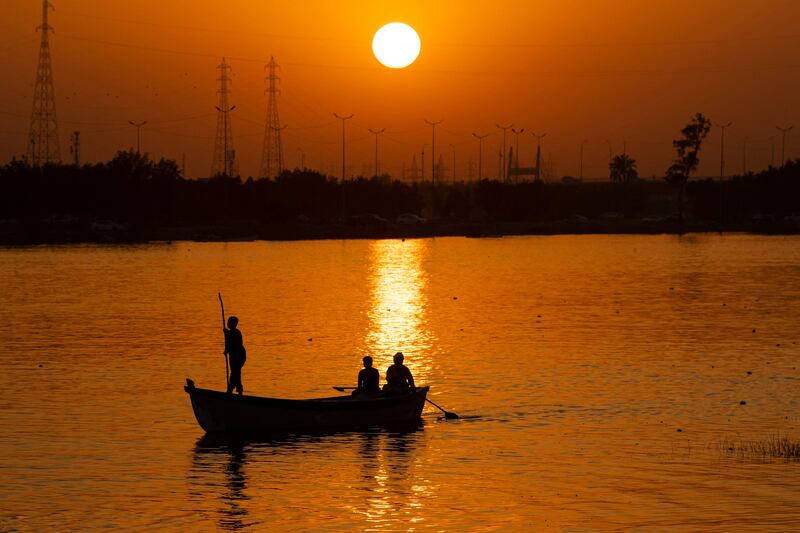 A man pilots a boat in the Shatt Al Arab waterway.