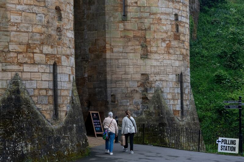 People walk towards Tonbridge Castle, being used as a polling station during local elections in Tonbridge. Reuters