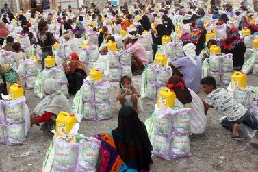 Displaced Yemenis from Durahemi receive food aid in the Red Sea port city of Hodeidah on August 9, 2019. AFP