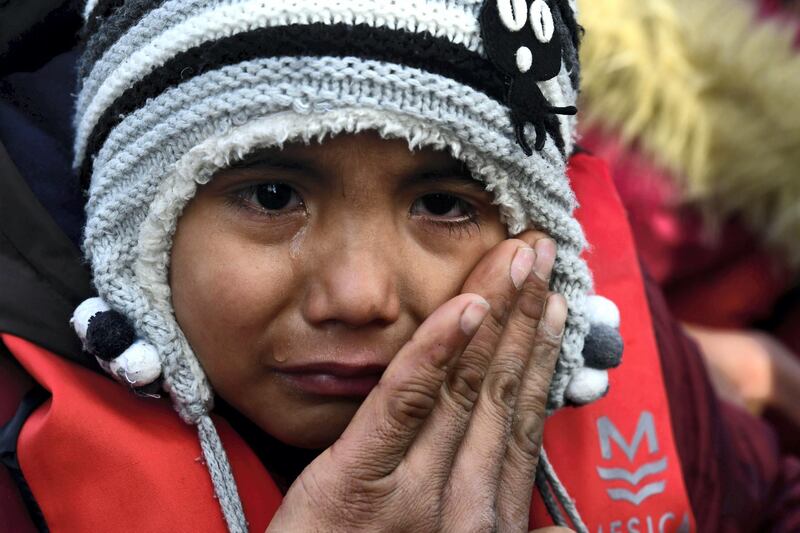 A child cries as he arrives at the village of Skala Sikaminias, on the Greek island of Lesbos, after crossing the Aegean sea from Turkey with other migrants, on Friday, Feb. 28, 2020. An air strike by Syrian government forces killed scores of Turkish soldiers in northeast Syria, a Turkish official said Friday, marking the largest death toll for Turkey in a single day since it first intervened in Syria in 2016. (AP Photo/Micheal Varaklas)