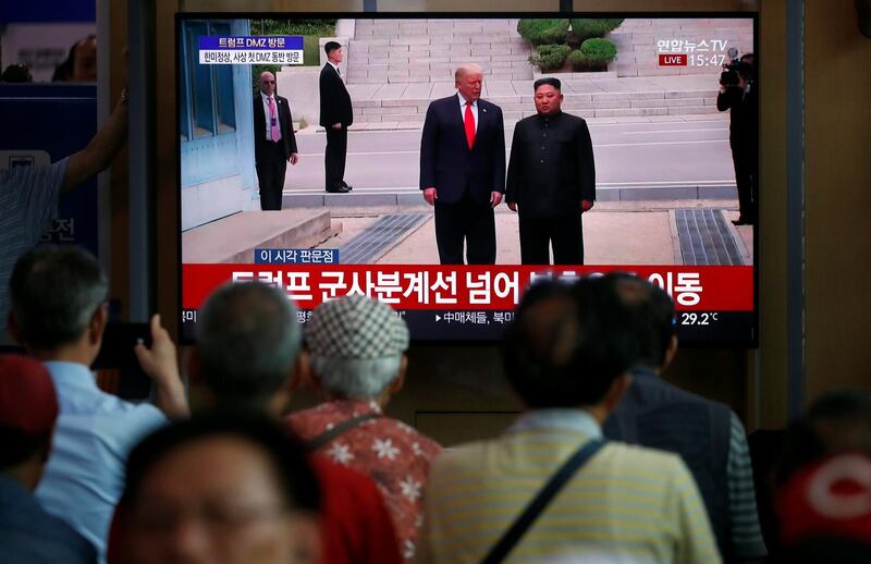 South Koreans watch a television broadcasting news of the event. EPA