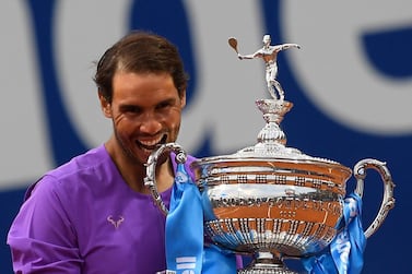 Spain's Rafael Nadal celebrates with the trophy after winning the ATP Barcelona Open tennis tournament singles final match against Greece's Stefanos Tsitsipas at the Real Club de Tenis in Barcelona on April 25, 2021. / AFP / Josep LAGO