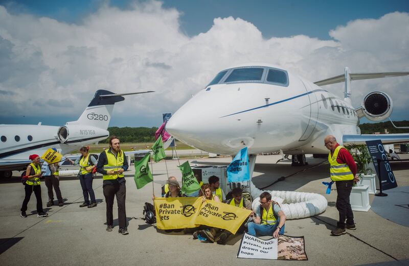 Environmental activists engage in a climate protest at the European Business Aviation Convention and Exhibition at Geneva Airport in Switzerland. AFP