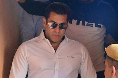 Salman Khan walks with officials as he leaves after a court appearance. AFP