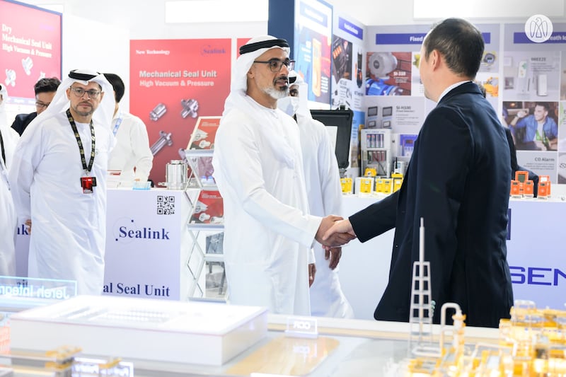 Sheikh Khaled is greeted by an executive at one of the stands at Adipec. Photo: Abu Dhabi Media Office