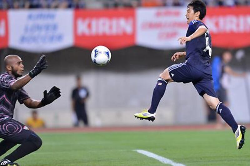 Japan forward Shinji Kagawa tries to beat UAE goalkeeper Ali Khaseif during their friendly.