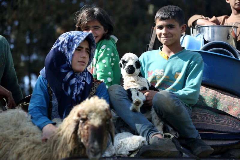 epa06601101 Internally displaced people from various areas under YPG control, arrive to the recently captured by the Free Syrian Army village of Qestel Cindo, Afrin, 13 March 2018. The Turkish army on 20 January 2018 launched 'Operation Olive Branch' in Syria's northern regions against the Kurdish Popular Protection Units (YPG) forces and the Syrian Democratic Forces (SDF) which control the city of Afrin. Turkey classifies the YPG as a terrorist organization. The Turkish-backed Free Syrian Army is an armed rebel military group that operates in northern Syria and is supported by the Turkish army.  EPA/AREF TAMMAWI