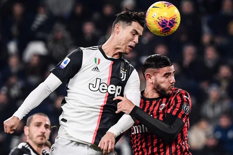 Juventus' Cristiano Ronaldo and AC Milan defender Theo Hernandez go for a header. AFP
