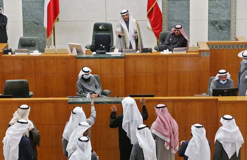 Kuwaiti MPs speak with parliament speaker Marzouq Al Ghanim, top centre, after the national assembly session was adjourned due to cabinet's resignation, in Kuwait City, in 2021. AFP