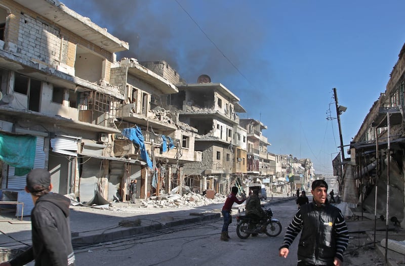 Smoke billows from a building following a reported bombardment by pro-Syrian government forces in the town of Maaret al-Numan in Syria's Idlib province, the country's last major opposition bastion, on December 20, 2019. (Photo by Abdulaziz KETAZ / AFP)