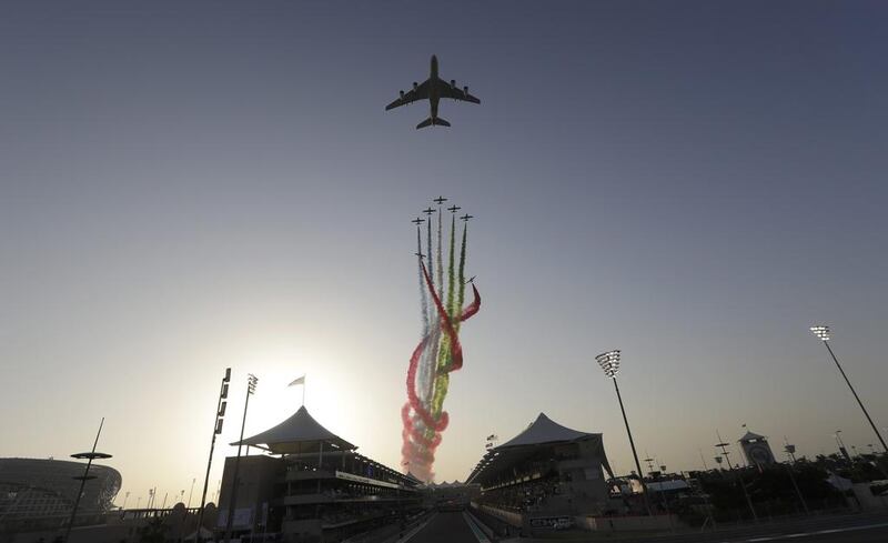 An Etihad A380 leads the Al Forsan aerobatic team before the race. Luca Bruno / AP Photo