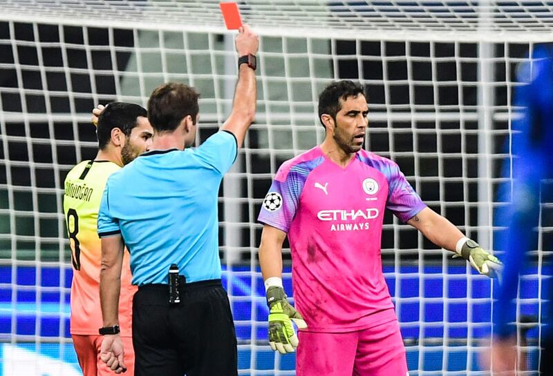 Referee Aleksei Kulbakov sneds off City goalkeeper Claudio Bravo. AFP