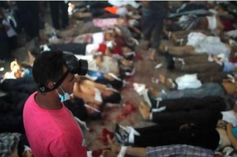 Bodies are laid out in a makeshift morgue after Egyptian security forces stormed two huge protest camps at the Rabaa Al Adawiya and Al Nahda squares in Cairo where supporters of ousted president Mohammed Morsi were camped.