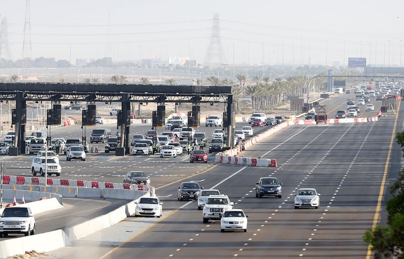 Abu Dhabi border checks for Covid-19 in place for commuters on the E11 on Sunday, December 19. Chris Whiteoak / The National