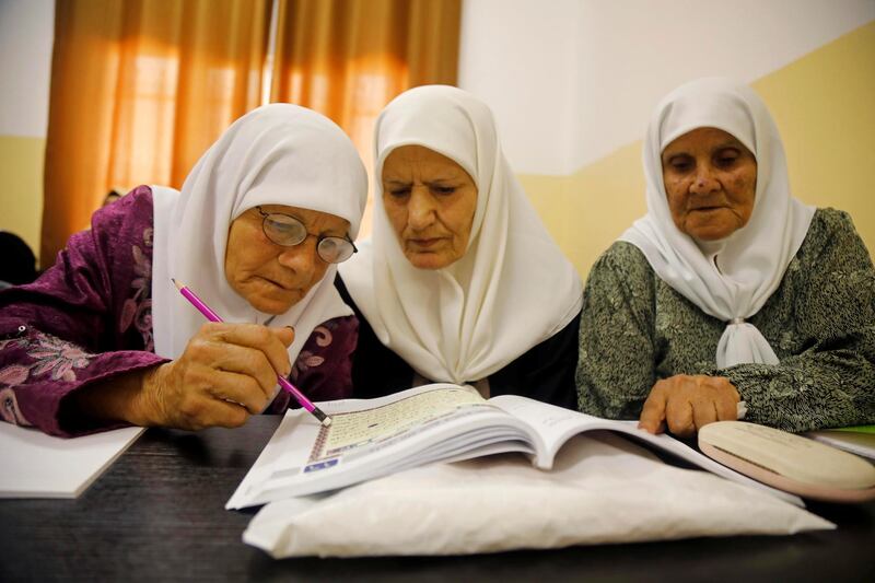Palestinian woman Seham Somodi, 66, takes part in a literacy class with her colleagues at Al Yamoun Community Center where they learn reading, writing and using computer, in Al Yamoun town in the Israeli-occupied West Bank. Reuter