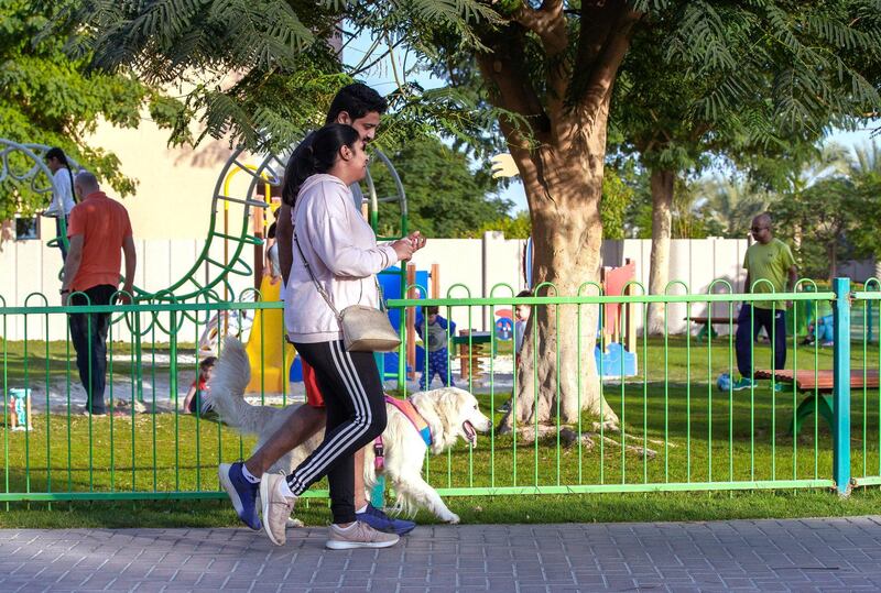 Abu Dhabi, United Arab Emirates, January 19, 2021.  Al Reef Village in Abu Dhabi.  A couple takes their dog for a walk.
Victor Besa/The National 
Section:  NA
Reporter:  Gillian Duncan