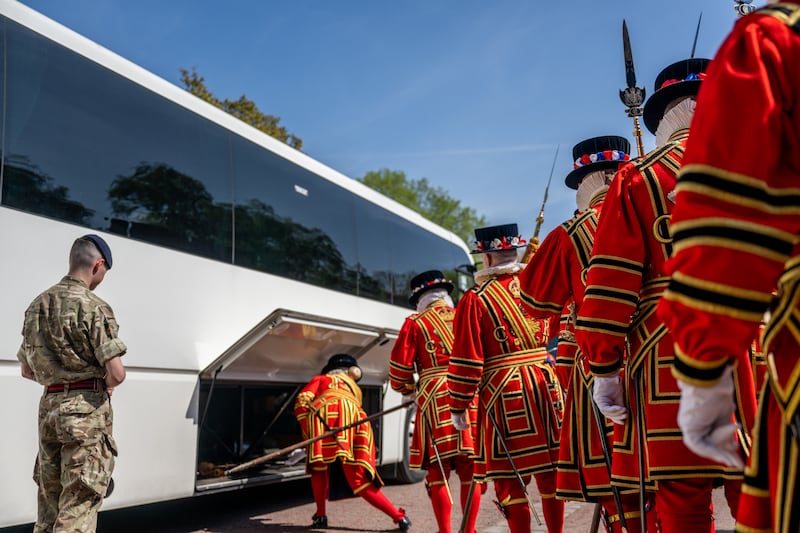 Yeoman of the Guard, the British sovereign's bodyguards, prepare to board a bus in London. Getty