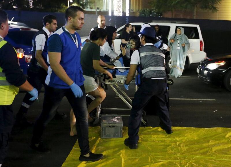 Medics evacuate a wounded person outside the Address Downtown Dubai hotel and residential block after a fire engulfed the skyscraper in downtown Dubai. Ahmed Jadallah / Reuters