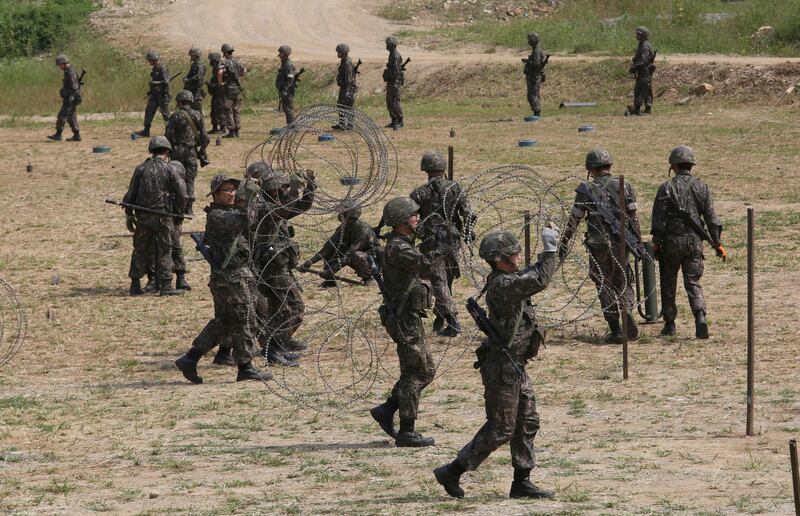 
                  South Korean army soldiers prepare barbed wires during a military exercise in Paju, South Korea, near the border with North Korea, Monday, Sept. 4, 2017. Following U.S. warnings to North Korea of a "massive military response," South Korea's military on Monday fired missiles into the sea to simulate an attack on the North's main nuclear test site a day after Pyongyang detonated its largest ever nuclear test explosion. (AP Photo/Ahn Young-joon)
               