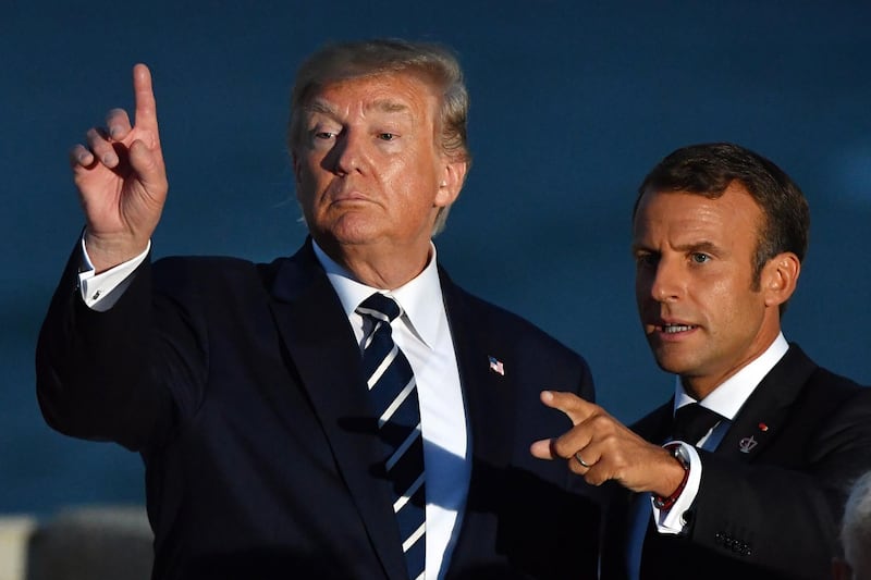 epa07795592 US President Donald Trump (L) and France's President Emmanuel Macron (R) gesture after the family photograph during the G7 summit in Biarritz, France, 25 August 2019 (isued 26 August 2019). The G7 Summit runs from 24 to 26 August in Biarritz.  EPA/MICK TSIKAS  AUSTRALIA AND NEW ZEALAND OUT