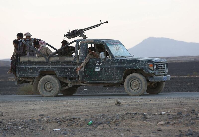 Fighters loyal to the government ride in a military truck in Marib. REUTERS