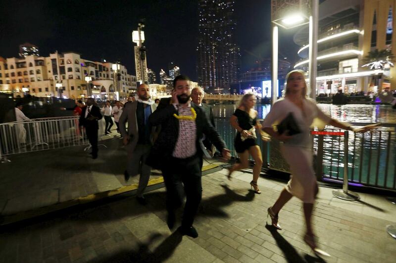 People run away as a fire engulfs the nearby The Address Hotel (not pictured) in downtown Dubai. Ahmed Jadallah / Reuters