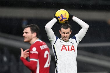 Tottenham Hotspurs Welsh midfielder Gareth Bale (R) takes a throw in during the English Premier League football match between Tottenham Hotspur and Liverpool at Tottenham Hotspur Stadium in London, on January 28, 2021. - RESTRICTED TO EDITORIAL USE. No use with unauthorized audio, video, data, fixture lists, club/league logos or 'live' services. Online in-match use limited to 120 images. An additional 40 images may be used in extra time. No video emulation. Social media in-match use limited to 120 images. An additional 40 images may be used in extra time. No use in betting publications, games or single club/league/player publications. / AFP / POOL / Shaun Botterill / RESTRICTED TO EDITORIAL USE. No use with unauthorized audio, video, data, fixture lists, club/league logos or 'live' services. Online in-match use limited to 120 images. An additional 40 images may be used in extra time. No video emulation. Social media in-match use limited to 120 images. An additional 40 images may be used in extra time. No use in betting publications, games or single club/league/player publications.