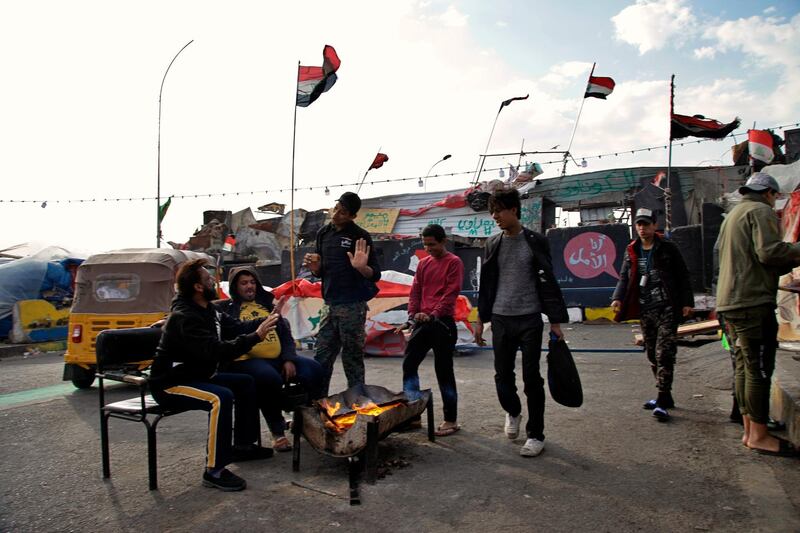 Protesters stage a sit-in on barriers at the Senak bridge leading to the heavily fortified Green Zone. AP Photo